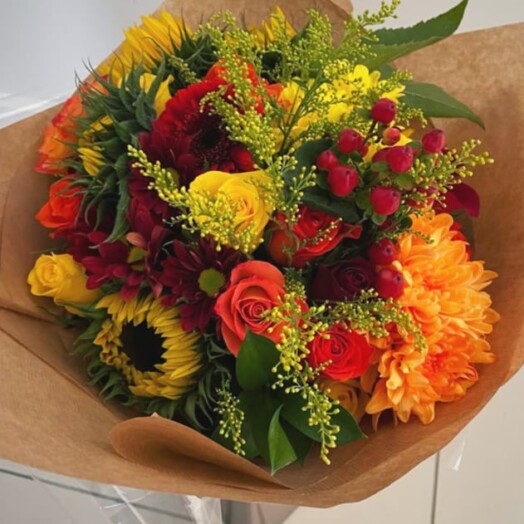 Deep blue thistles compliment bold Sunflowers with burst of orange Roses for a unique design. Next Day Delivery, Wickford, Essex, Hertfordshire.